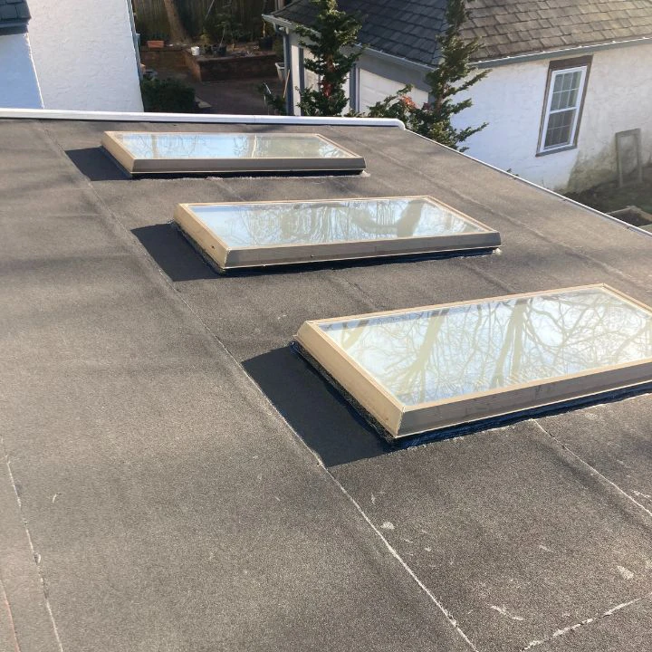 New flat roof with skylight installation
