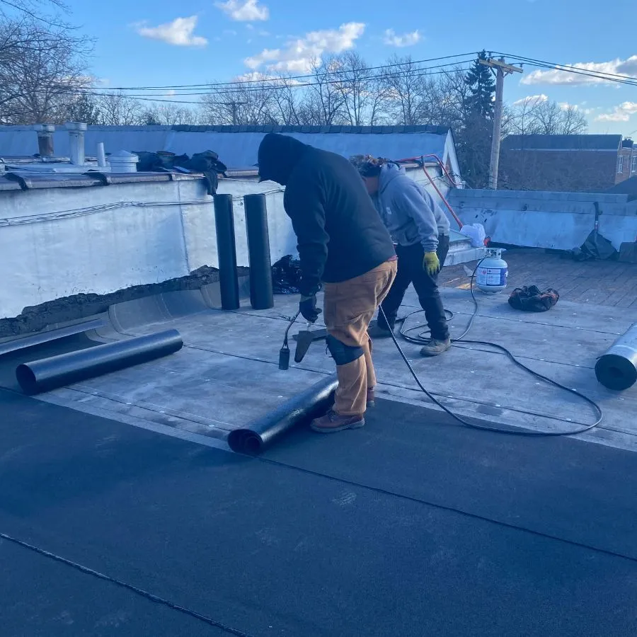 Torch down flat roof installation in progress