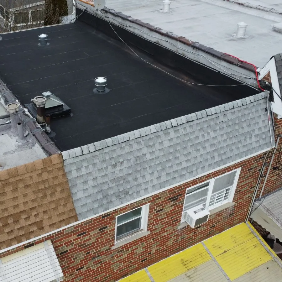 Aerial view of flat and shingle roof sections
