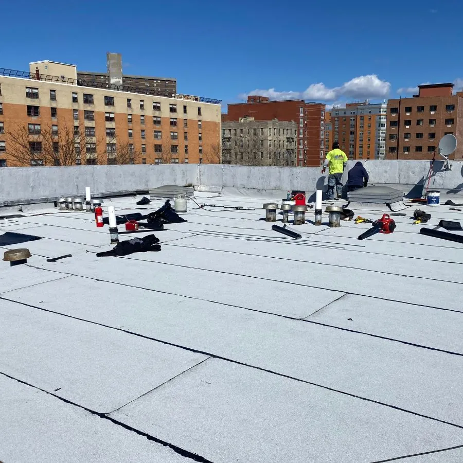 Flat roof membrane installation on commercial building