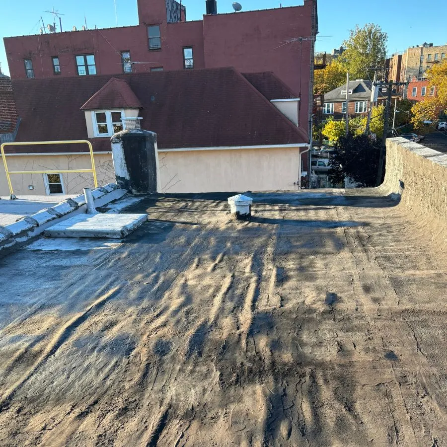 Flat roof surface wear and standing water issues in the Bronx