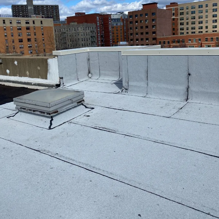 Flat roof surface with skylight and waterproofing