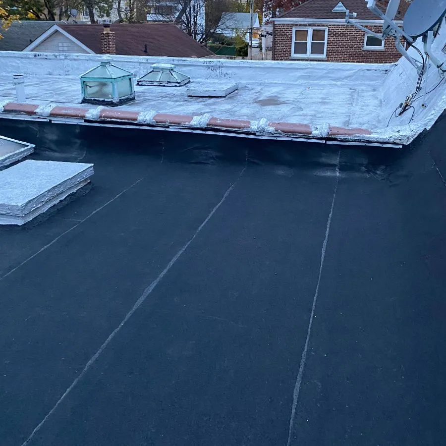 Flat roof transition with skylights and satellite dish