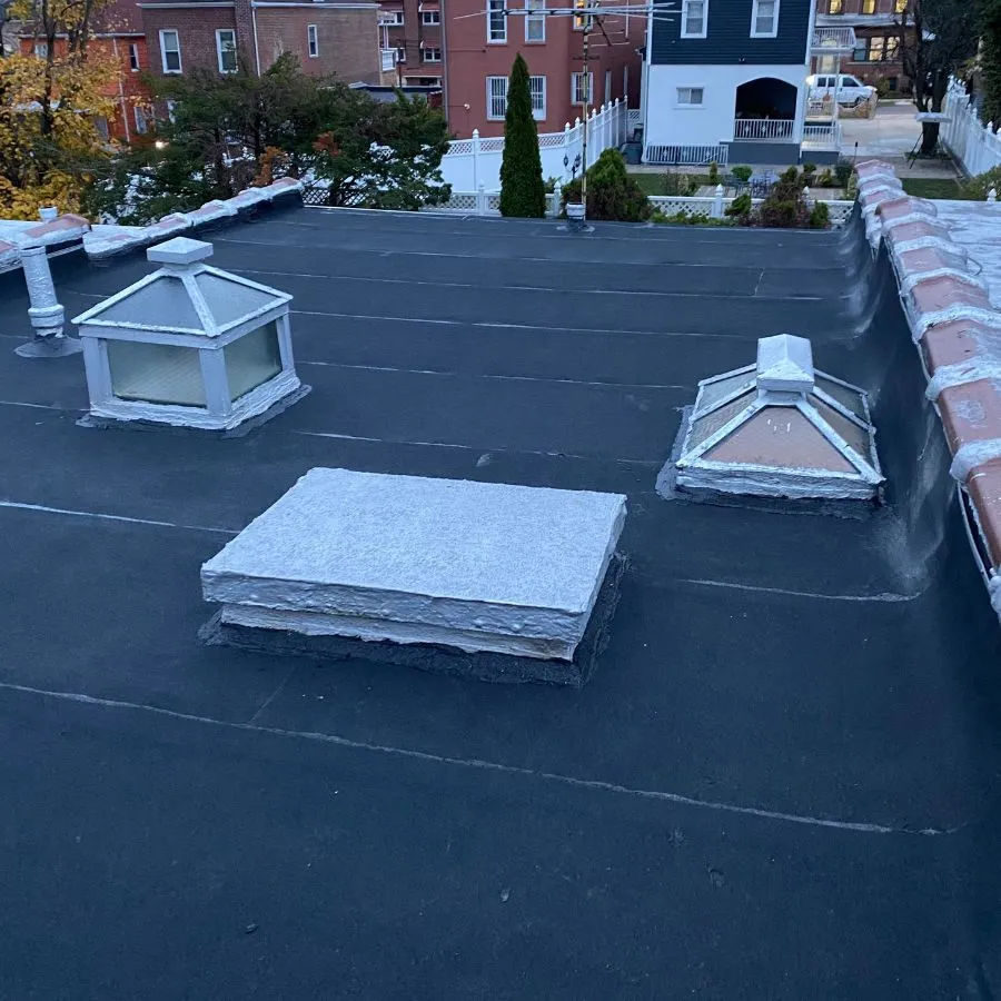 Flat roof with skylights and freshly applied coating