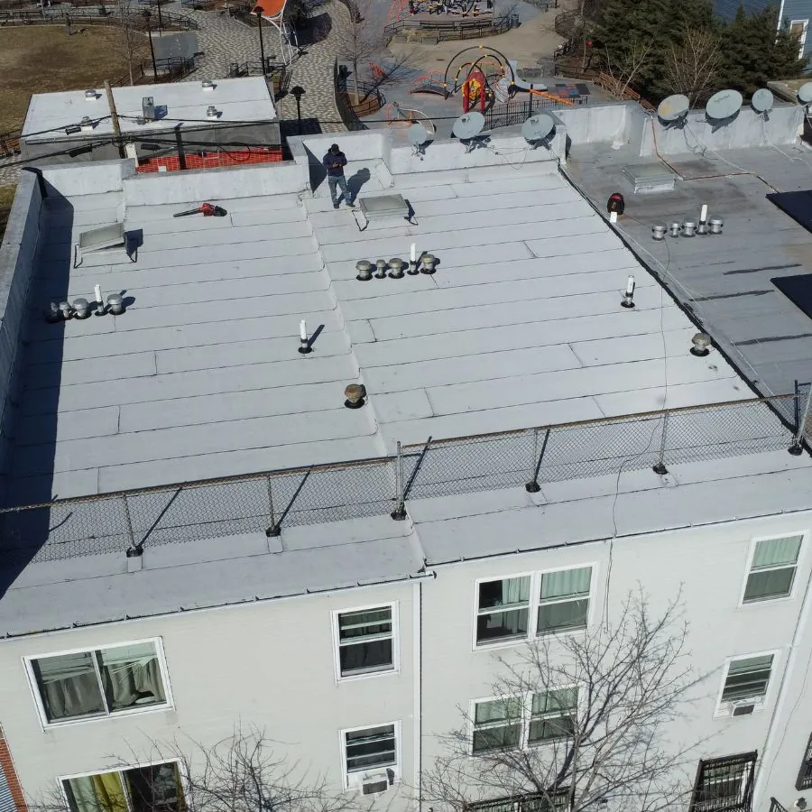 Flat white commercial rooftop with satellite dishes