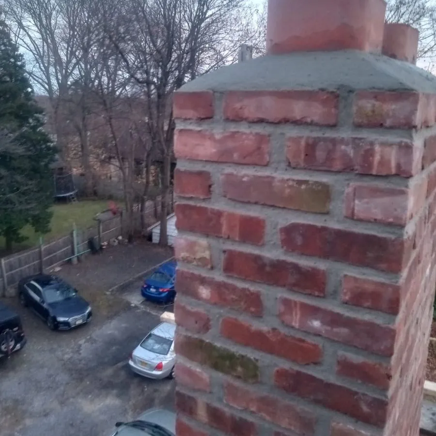 High chimney view with parked cars below in Bronx NY