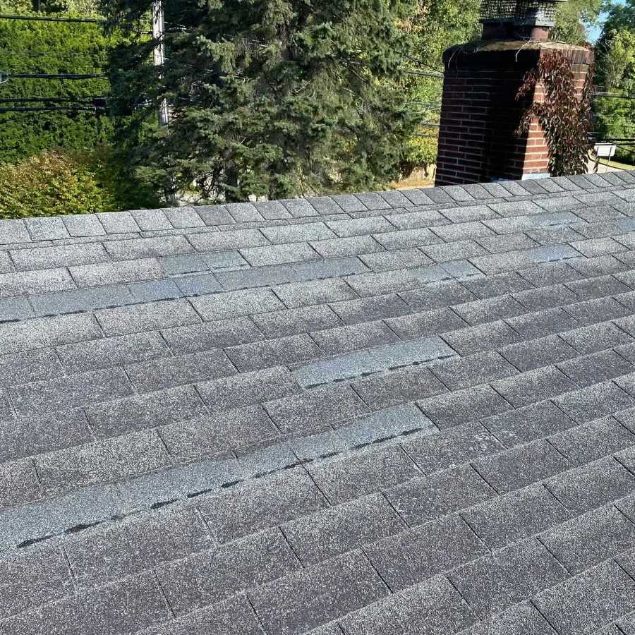 Asphalt shingle roof repair with chimney