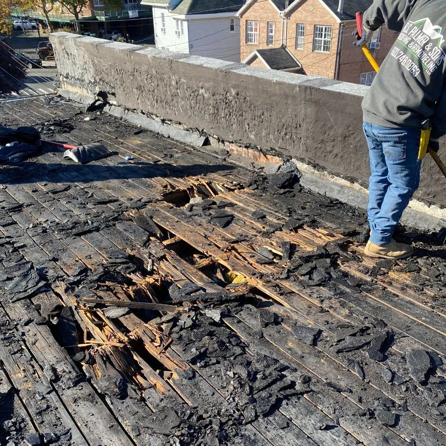 Roof demolition exposing rotten wood decking