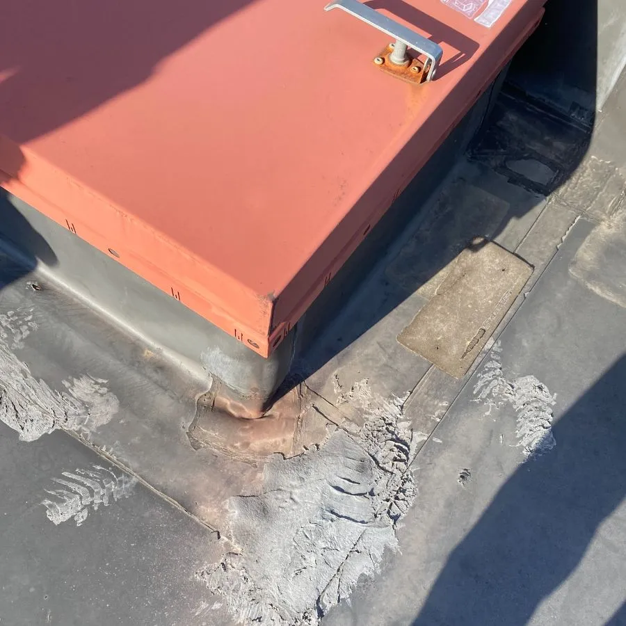 Roof hatch flashing damage and sealant wear